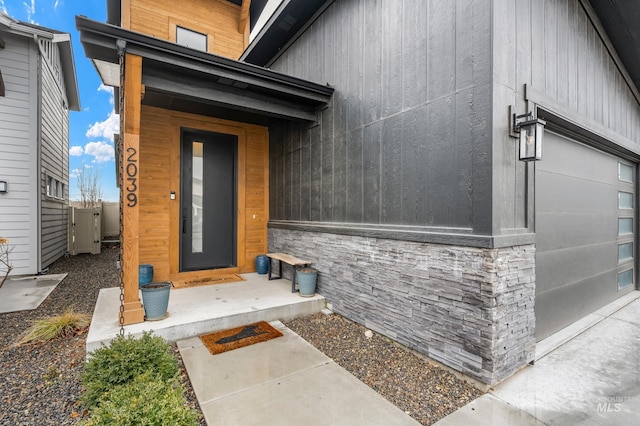 entrance to property featuring stone siding