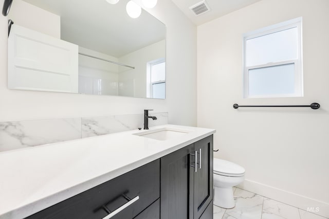 bathroom with vanity, baseboards, visible vents, toilet, and marble finish floor