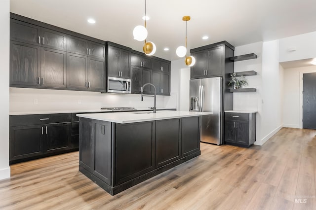 kitchen featuring open shelves, stainless steel appliances, light wood finished floors, and light countertops