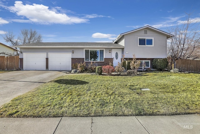 tri-level home featuring a garage and a front yard