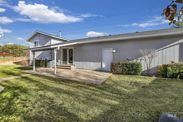 back of property featuring a lawn, cooling unit, and a patio