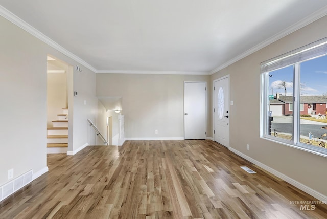 unfurnished living room featuring light hardwood / wood-style floors and crown molding