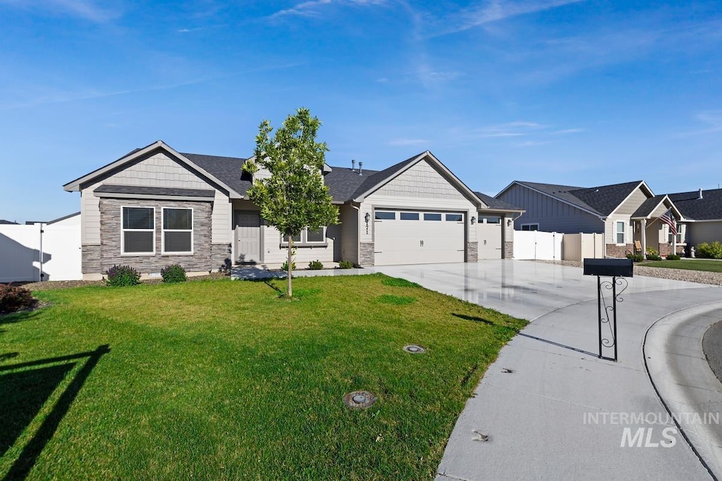 view of front facade with a front yard and a garage