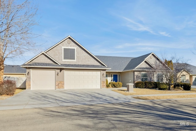 view of front of house featuring stone siding, driveway, and fence