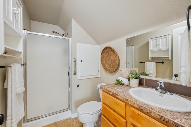 bathroom featuring toilet, walk in shower, tile patterned floors, vanity, and vaulted ceiling