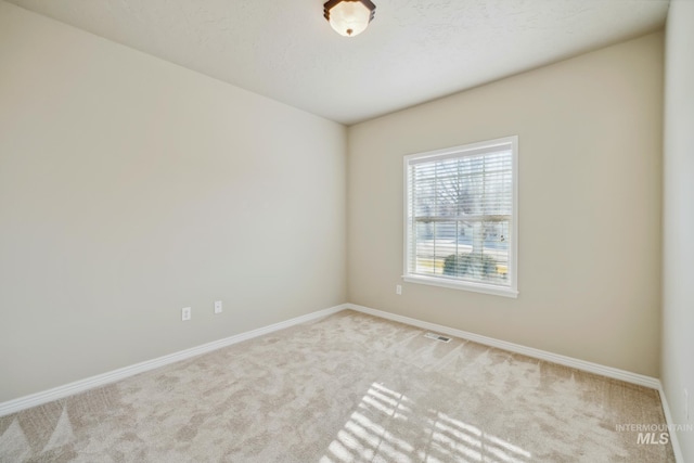 empty room featuring light carpet