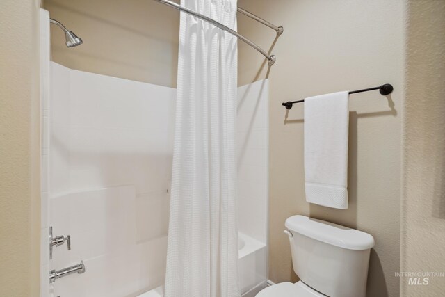 bathroom with toilet and shower / bath combo