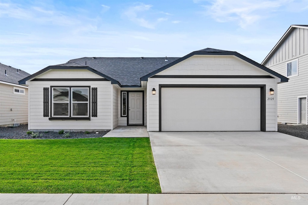 single story home featuring a front yard and a garage