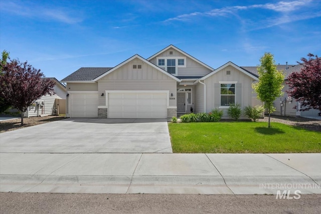 5006 Clearfield St, Caldwell, ID 83605 - view of front of house with board and batten siding, an attached garage, driveway, and a front lawn