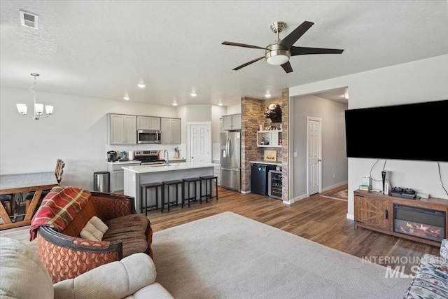 5006 Clearfield St, Caldwell, ID 83605 - living room with a chandelier, wood finished floors, ceiling fan, recessed lighting, and baseboards