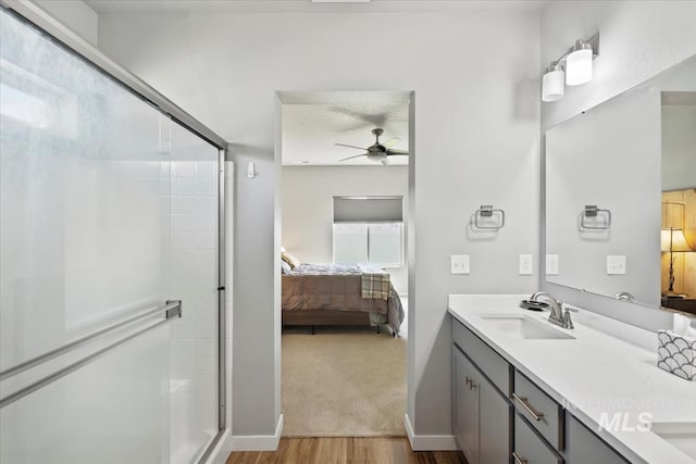 5006 Clearfield St, Caldwell, ID 83605 - full bath featuring connected bathroom, wood finished floors, double vanity, ceiling fan, and a shower stall
