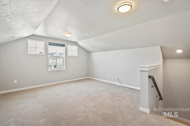 5006 Clearfield St, Caldwell, ID 83605 - additional living space featuring baseboards, carpet, vaulted ceiling, and a textured ceiling