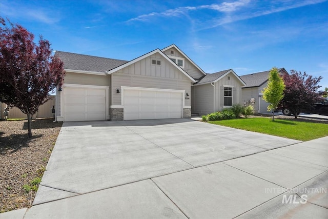 5006 Clearfield St, Caldwell, ID 83605 - view of front facade with board and batten siding, an attached garage, concrete driveway, stone siding, and roof with shingles