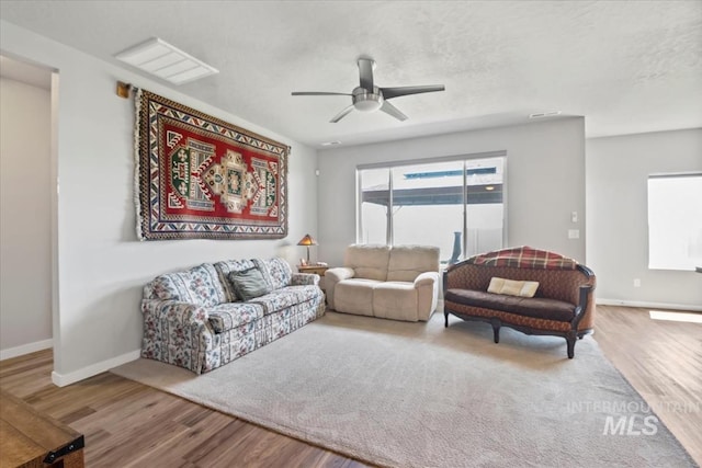 5006 Clearfield St, Caldwell, ID 83605 - living room with wood finished floors, ceiling fan, baseboards, and a textured ceiling