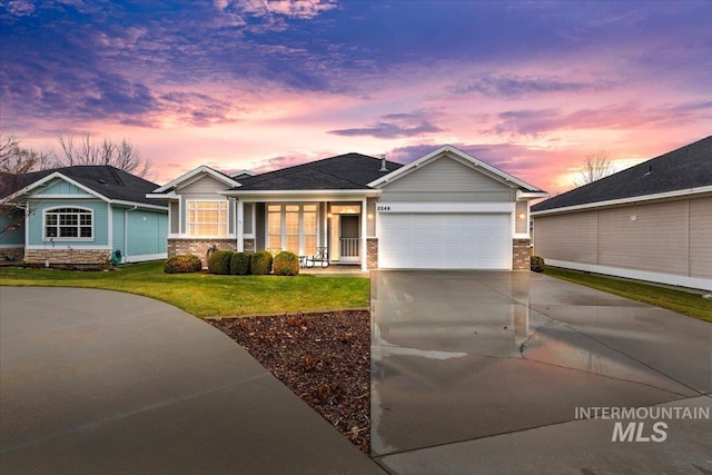 view of front of house with a yard and a garage