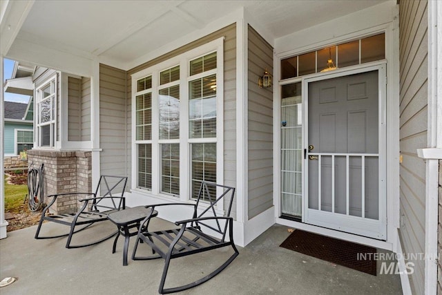 view of exterior entry with a porch