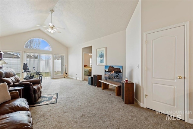 living room featuring carpet flooring, a textured ceiling, ceiling fan, and lofted ceiling