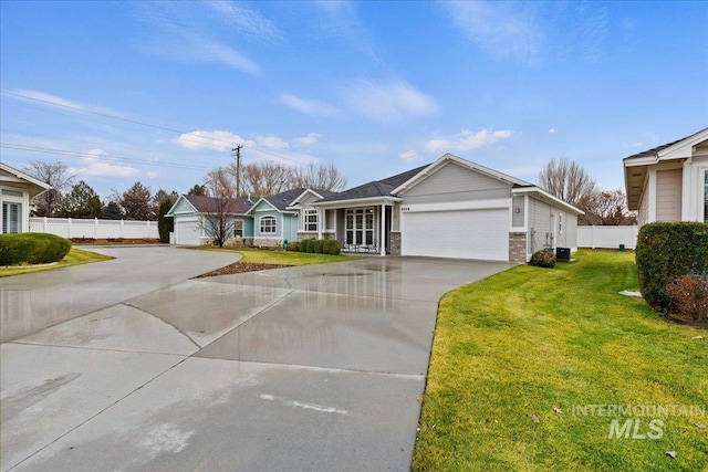 ranch-style house featuring a front lawn and a garage