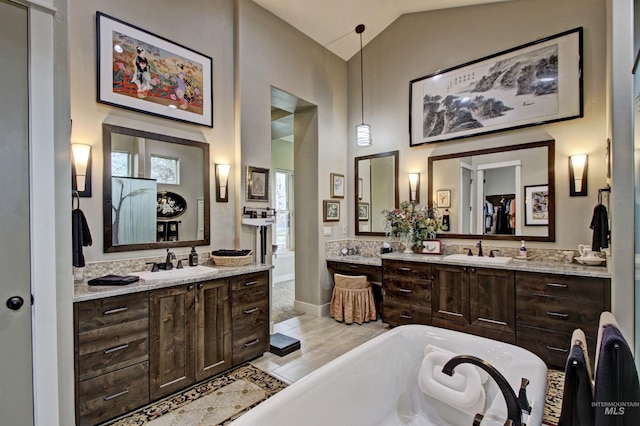 2468 E Lodge Trail Dr, Meridian, ID 83642 - bathroom with a sink, two vanities, a freestanding bath, and high vaulted ceiling