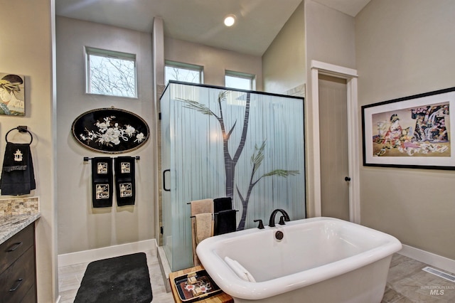 2468 E Lodge Trail Dr, Meridian, ID 83642 - bathroom featuring visible vents, baseboards, a freestanding tub, a shower stall, and vanity