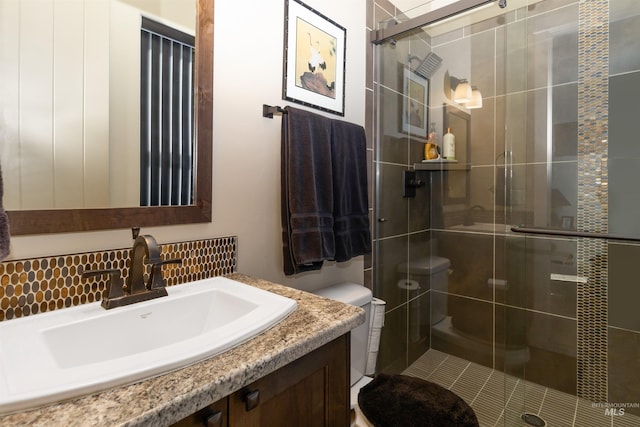 2468 E Lodge Trail Dr, Meridian, ID 83642 - full bath with toilet, vanity, a shower stall, and decorative backsplash