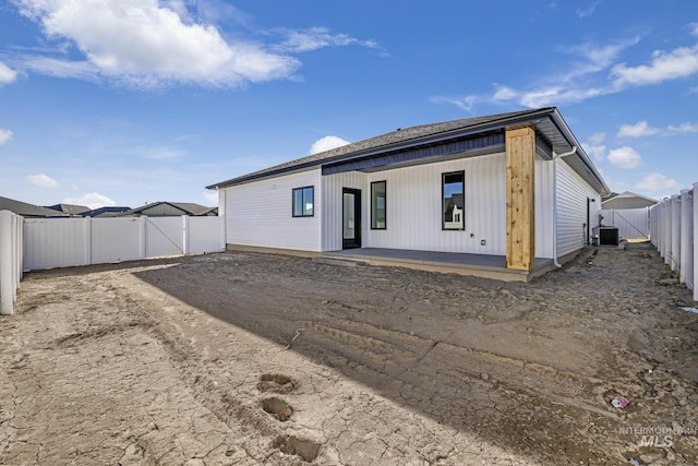 rear view of property with central air condition unit