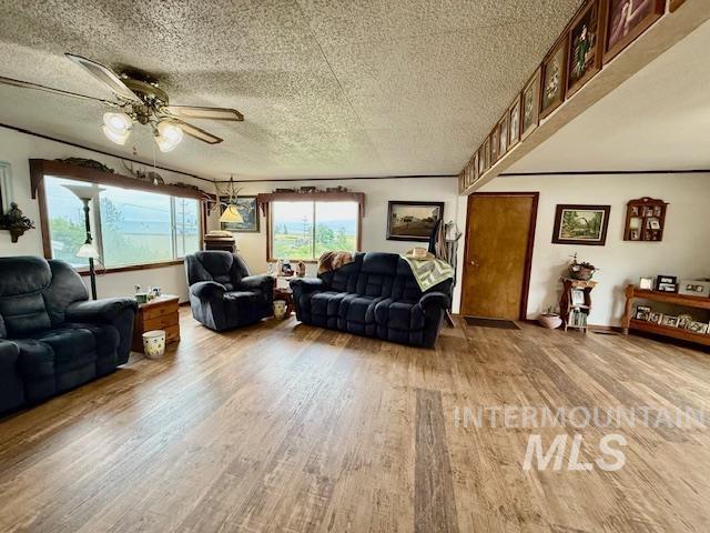 908 Pine St, Anatone, WA 99401 - living room featuring wood finished floors, ceiling fan, and a textured ceiling