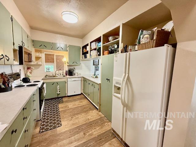 908 Pine St, Anatone, WA 99401 - kitchen with white appliances, open shelves, green cabinets, and light wood finished floors