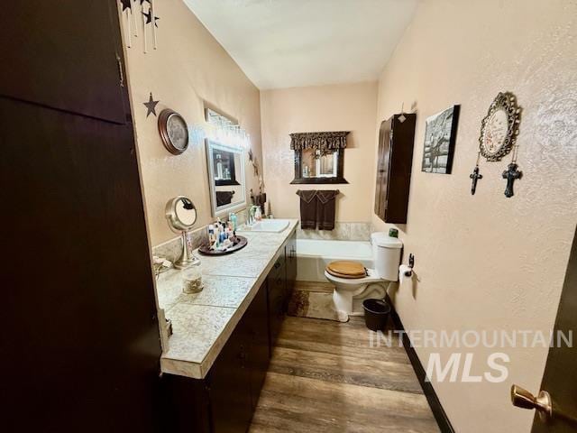 908 Pine St, Anatone, WA 99401 - full bath featuring wood finished floors, a tub to relax in, and double vanity
