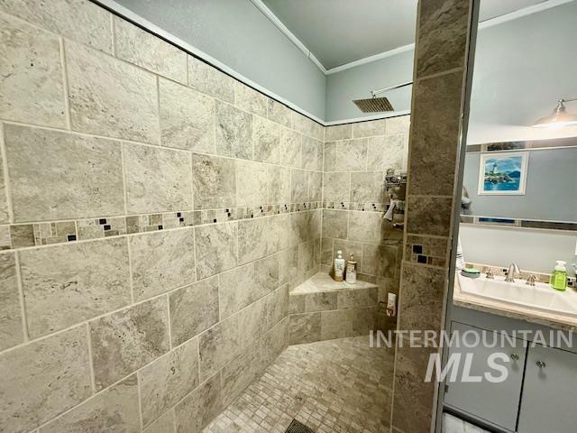 908 Pine St, Anatone, WA 99401 - full bathroom with tiled shower, crown molding, and vanity
