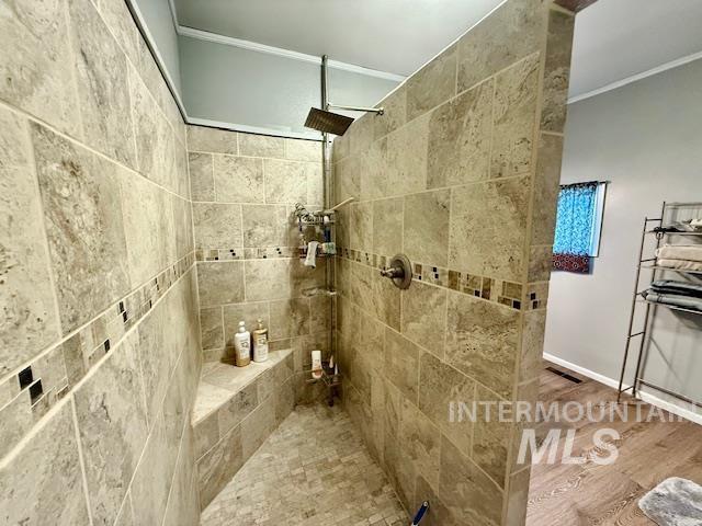 908 Pine St, Anatone, WA 99401 - full bath featuring ornamental molding, tiled shower, and wood finished floors