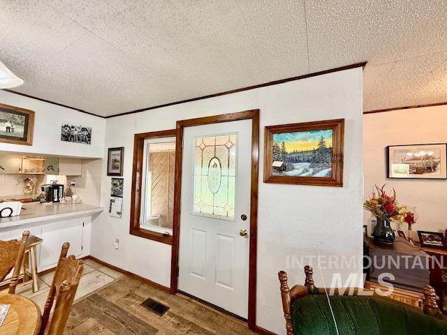 908 Pine St, Anatone, WA 99401 - foyer entrance with a textured ceiling and light wood finished floors