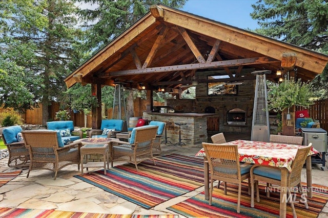 view of patio / terrace with a gazebo and an outdoor living space with a fireplace