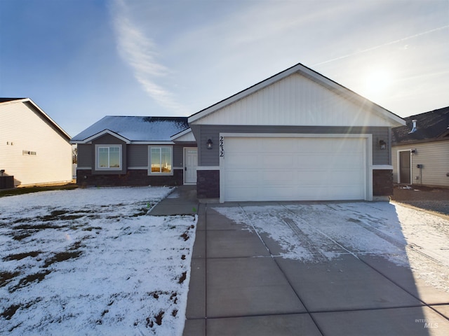 ranch-style home featuring central air condition unit and a garage