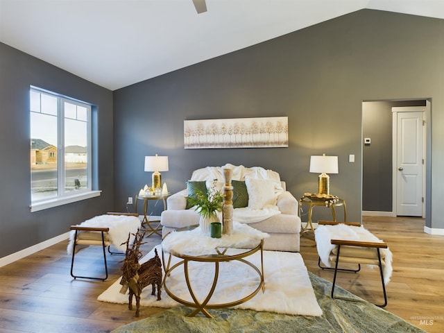 living room with vaulted ceiling and hardwood / wood-style flooring