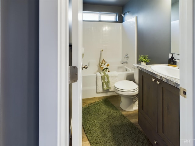 full bathroom featuring shower / washtub combination, hardwood / wood-style floors, vanity, and toilet