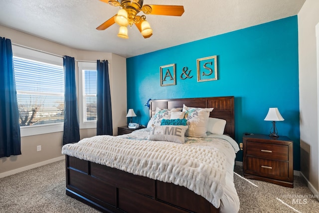 carpeted bedroom featuring a textured ceiling and ceiling fan