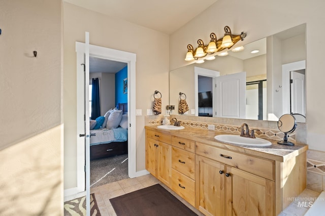 bathroom featuring tile patterned floors, decorative backsplash, and vanity