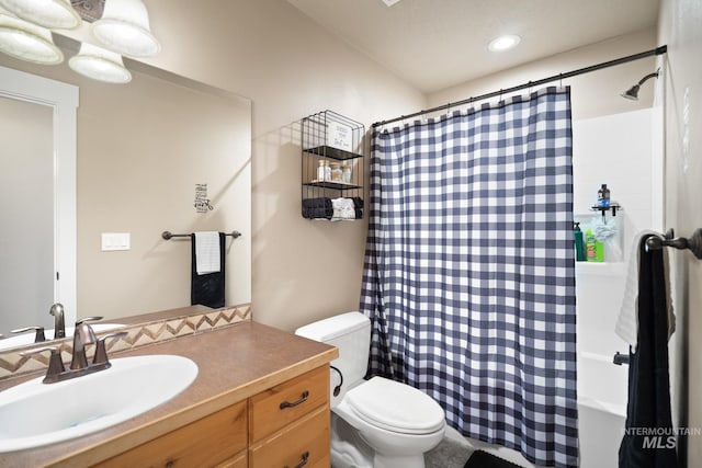 full bathroom with vanity, shower / bathtub combination with curtain, and toilet