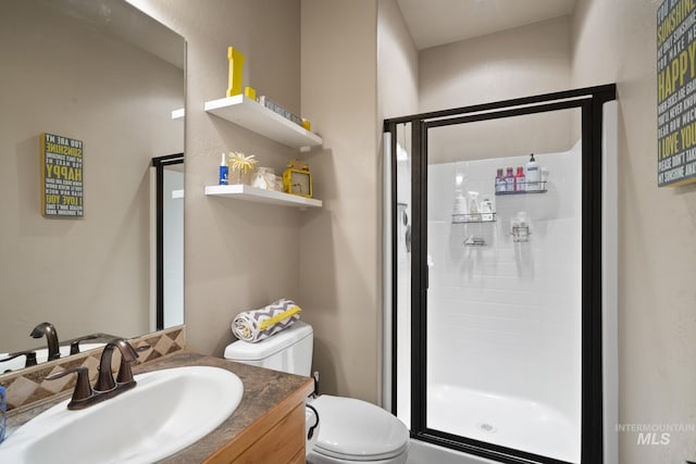 bathroom with vanity, toilet, and an enclosed shower