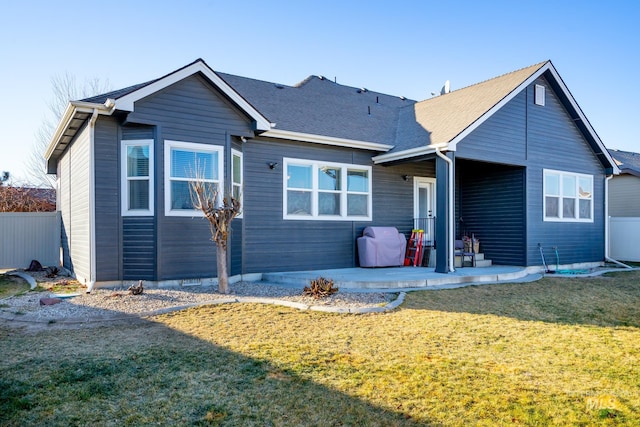 rear view of house featuring a patio area and a lawn