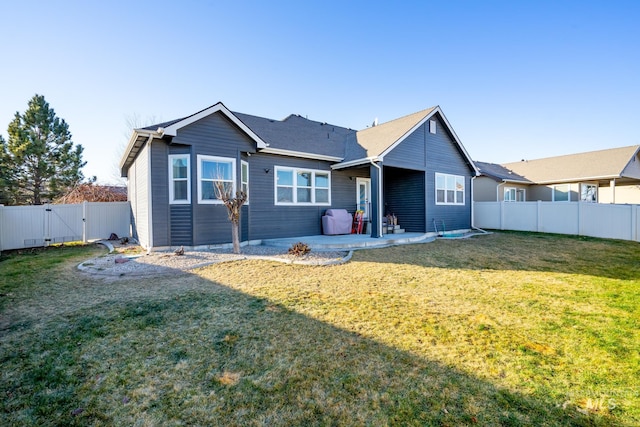 rear view of property featuring a patio area and a lawn