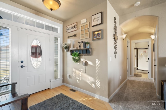 entrance foyer featuring plenty of natural light and light hardwood / wood-style floors