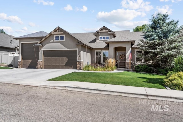 craftsman house with a garage, driveway, stone siding, stucco siding, and a front lawn