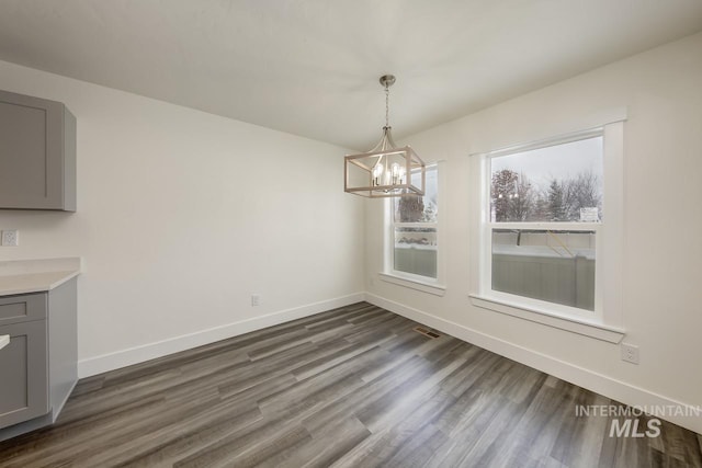TBD Drum Ln Lot 3A, Parma, ID 83660 - unfurnished dining area featuring a chandelier, dark wood-style floors, and baseboards