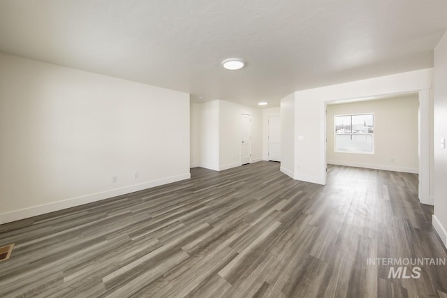 TBD Drum Ln Lot 3A, Parma, ID 83660 - unfurnished living room with dark wood-style flooring and baseboards