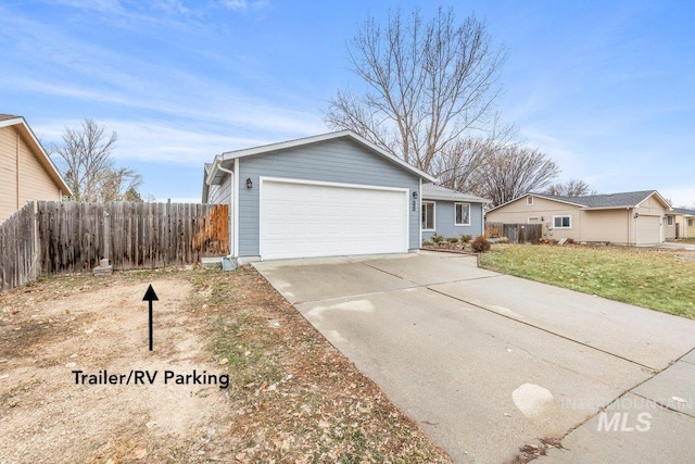 ranch-style home with a garage and a front yard