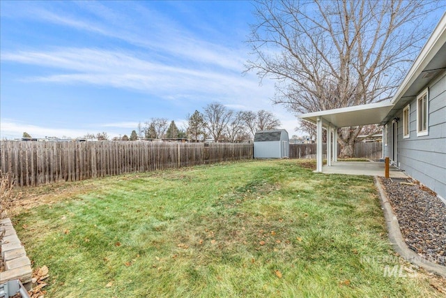 view of yard with a storage shed and a patio area