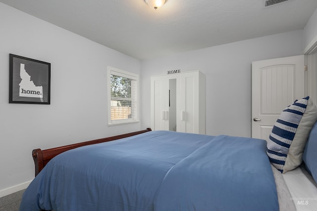 bedroom featuring baseboards and carpet
