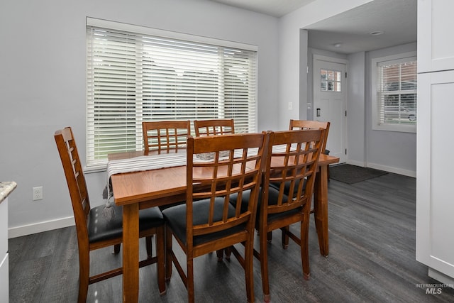 dining area featuring dark wood finished floors and baseboards